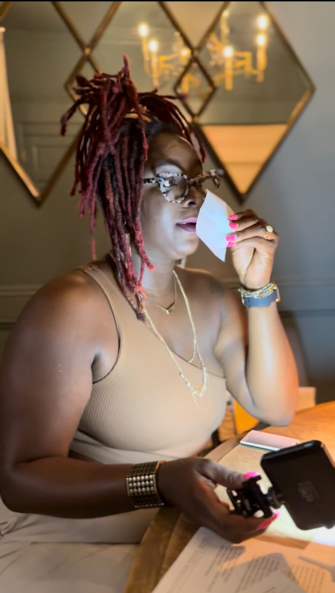 Antwonette reviewing notes and a receipt at a restaurant table