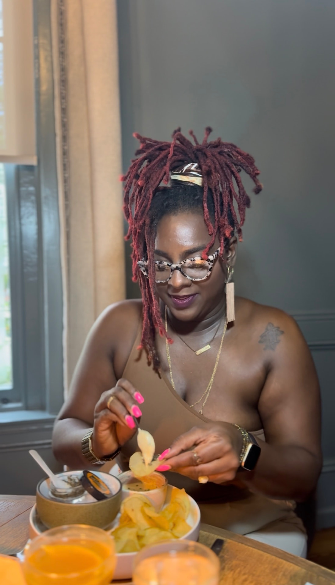 Antwonette tasting a dish at a table set with small plates